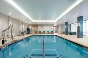 a pool with blue water in a hotel room at Homewood Suites By Hilton Southaven in Southaven