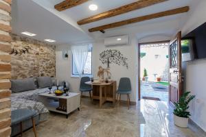 a living room with a couch and a table at Volto Suites in Corfu Town