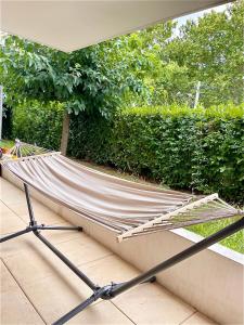 a hammock on a patio in front of a hedge at A Sainte marguerite in Nice