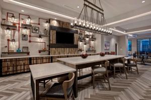 a dining room with a table and some chairs at Hampton Inn & Suites San Antonio Riverwalk in San Antonio