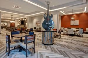 a restaurant with a guitar in the middle of a room at Hampton Inn & Suites San Antonio Riverwalk in San Antonio