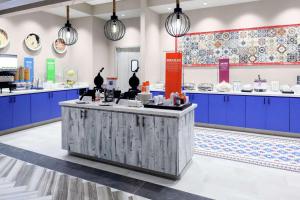 a kitchen with blue cabinets and a counter at Hampton Inn & Suites San Antonio Riverwalk in San Antonio