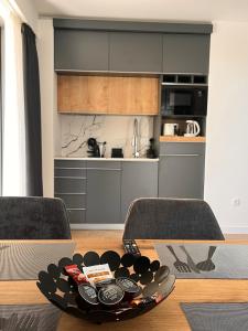 a living room with a table and a kitchen at Мamma Mia Аpartments in Budva