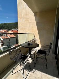 a table and chairs on a balcony with a view at Мamma Mia Аpartments in Budva