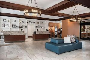 a lobby of a hotel with a blue couch at Embassy Suites by Hilton Nashville Airport in Nashville