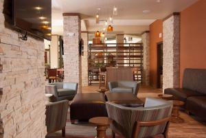 a lobby with couches and chairs in a restaurant at Embassy Suites by Hilton Nashville Airport in Nashville