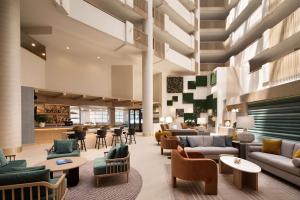 a lobby with couches and chairs and a bar at Hilton Santa Monica in Los Angeles