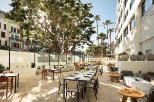 a restaurant with tables and chairs on a patio at Hilton Santa Monica in Los Angeles