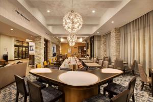 a restaurant with tables and chairs and a chandelier at Homewood Suites By Hilton Louisville Downtown in Louisville