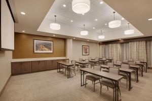 a conference room with tables and chairs and a podium at Homewood Suites By Hilton Louisville Downtown in Louisville +25 photos