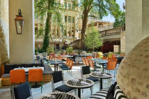 a restaurant with tables and chairs in a courtyard at Canopy By Hilton San Antonio Riverwalk in San Antonio
