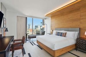 a hotel room with a bed and a desk at Canopy By Hilton San Antonio Riverwalk in San Antonio