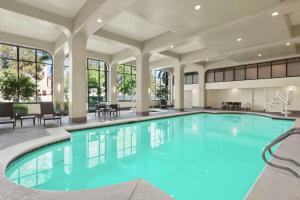 a swimming pool with blue water in a building at Embassy Suites by Hilton Arcadia-Pasadena Area in Arcadia