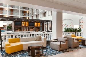 a lobby of a hotel with couches and a bar at Embassy Suites San Luis Obispo in San Luis Obispo