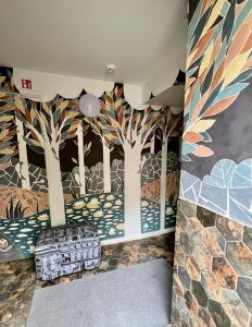 a room with a mural of trees on the wall at Avers House in Narva