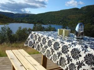 a blue and white table with a view of a lake at Panoramahytte in Norheimsund +20 photos