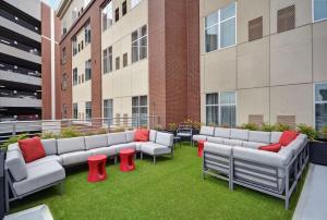 a group of couches sitting on the grass in a building at Homewood Suites by Hilton Athens Downtown University Area in Athens