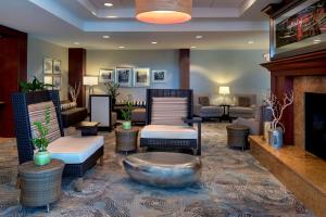 a lobby with a living room with a fireplace at Hilton Garden Inn Albany Medical Center in Albany