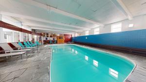a swimming pool in a building with blue tiles at Trade Winds Inn in Rockland