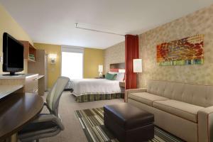 a hotel room with a bed and a couch at Home2 Suites by Hilton - Oxford in Oxford
