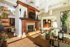 a living room with a fireplace and a tv at Hilton Garden Inn Anderson in Anderson