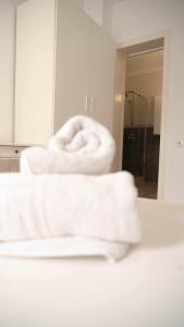 a pile of towels sitting on a counter in a bathroom at Hostal Paraiso del Mar in Torre del Mar