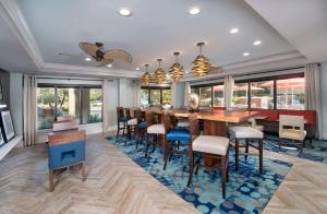 a dining room with a table and chairs and windows at Hampton Inn Naples - I-75 in Naples