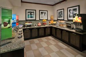 a kitchen with wooden cabinets and a counter top at Hampton Inn Ann Arbor-South in Ann Arbor