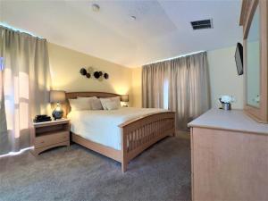 a bedroom with a bed and a television in it at Restful Single Home with BBQ Heated Pool and SPA in Kissimmee