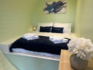 a bedroom with a bed with towels on it at Green Law - Dog Friendly in Penicuik