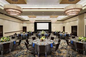 a banquet hall with tables and chairs and a projection screen at Hilton Garden Inn Atlanta Downtown in Atlanta +37 photos