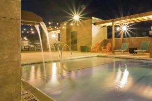 a swimming pool at night with lights at Home2 Suites by Hilton Atlanta Newnan in Newnan