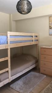 a wooden bunk bed in a room with a dresser at SPA - Casa do Avo BESELGA in Santo Amaro