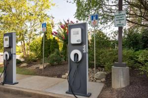 a row of parking meters sitting on a sidewalk at Hilton Garden Inn Atlanta Northpoint in Alpharetta