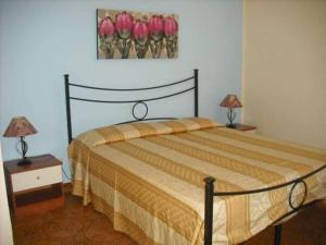 a bedroom with a bed with two lamps on tables at casa vacanze Sciaraba in Mazara del Vallo