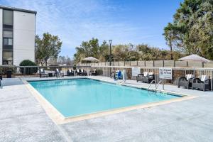 a large swimming pool with chairs at Hampton Inn Auburn in Auburn