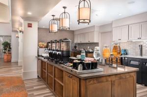 a large kitchen with a large island in a room at Homewood Suites by Hilton Austin South in Austin