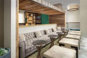 a waiting room with a couch and stools at Homewood Suites by Hilton Austin Downtown in Austin