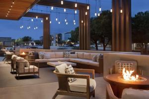 a lobby with couches and chairs and a fire pit at Hilton Garden Inn Austin North-Near the Domain, TX in Austin