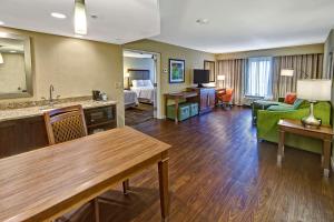 a hotel room with a living room with a couch and a table at Hampton Inn and Suites Asheville Airport in Fletcher
