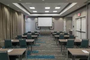 Hampton Inn & Suites Asheville Biltmore Area في أشفيل: قاعة اجتماعات مع طاولات وكراسي وشاشة بيضاء