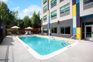 a swimming pool in front of a building at Tru By Hilton Asheville East, NC in Asheville