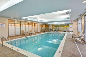 a large swimming pool with blue water in a building at Home2 Suites By Hilton Dickson City Scranton in Dickson City