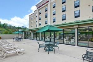 a patio with tables and chairs and a hotel at Hampton Inn & Suites Wilkes-Barre in Wilkes-Barre