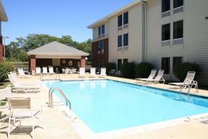 a large swimming pool with chairs and a building at Hampton Inn & Suites Newtown in Yardley