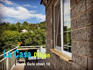 a window on the side of a brick building with trees at Bedroom La Casa Dilijan N1 in Dilijan