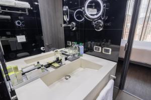 a bathroom with a sink and a mirror at GHL Hotel Bioxury in Bogotá