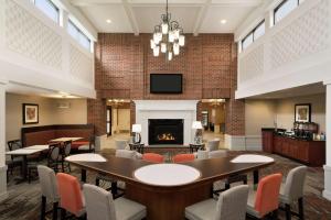 a lobby with tables and chairs and a fireplace at Homewood Suites by Hilton Newtown - Langhorne, PA in Newtown