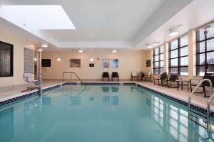 a swimming pool with blue water in a building at Homewood Suites by Hilton Newtown - Langhorne, PA in Newtown
