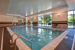 a large swimming pool in a building with windows at Hampton Inn & Suites - Columbia South, MD in Columbia